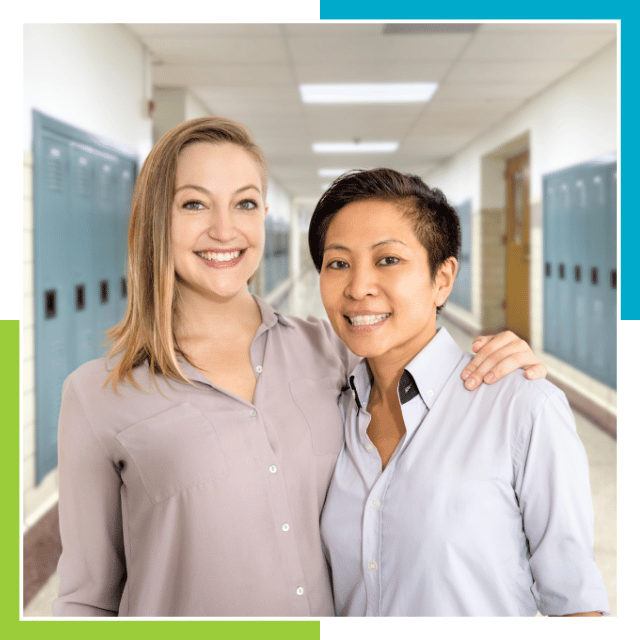 Two professional ASL interpreters smiling in a school hallway. Ready to assist you with sign language services.